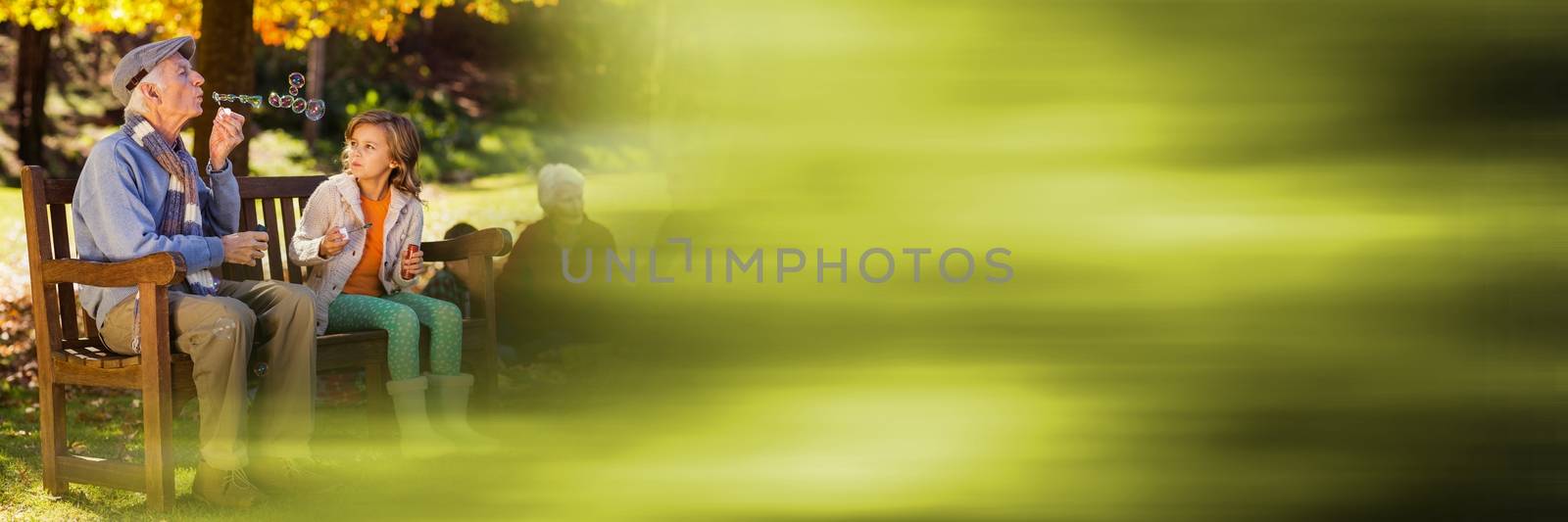 Family in park blowing bubbles and blurry green transition by Wavebreakmedia