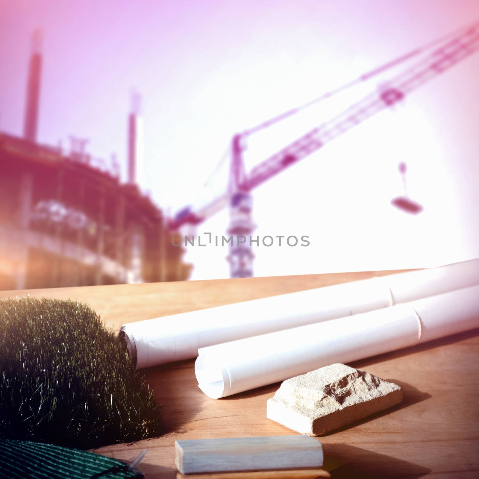 Architecture equipment on table against  crane and building construction site  Crane and building construction site on a sunny day