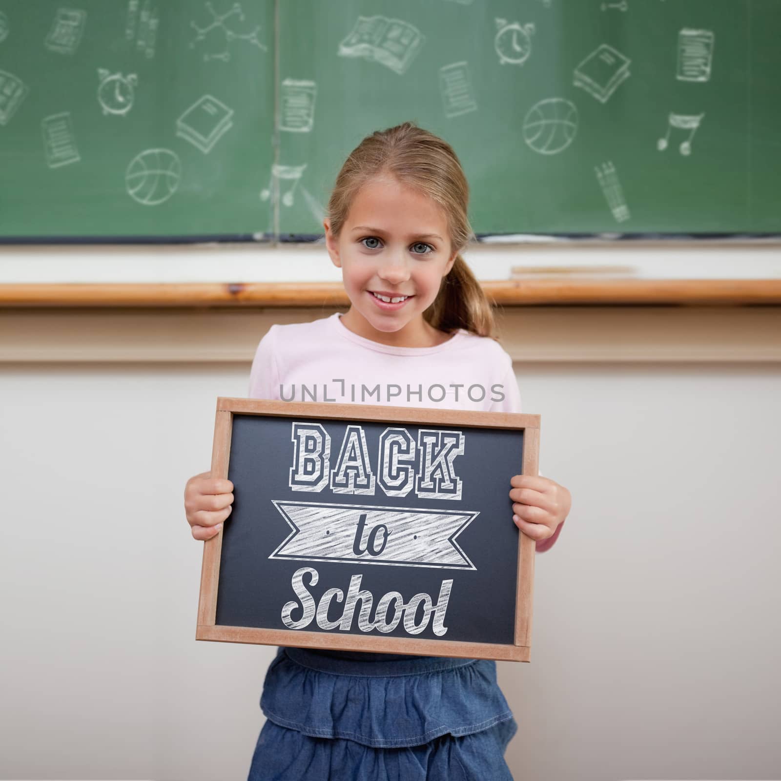 Back to school message against cute pupil showing chalkboard