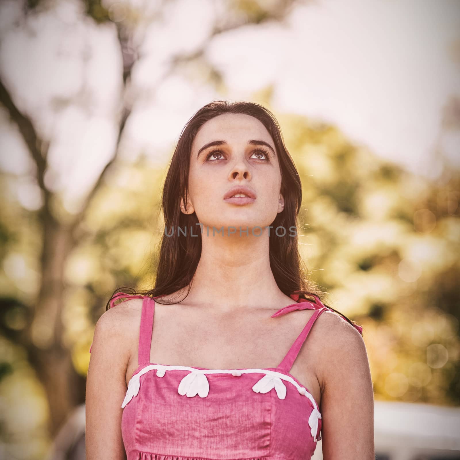 Low angle view of thoughtful woman standing in park