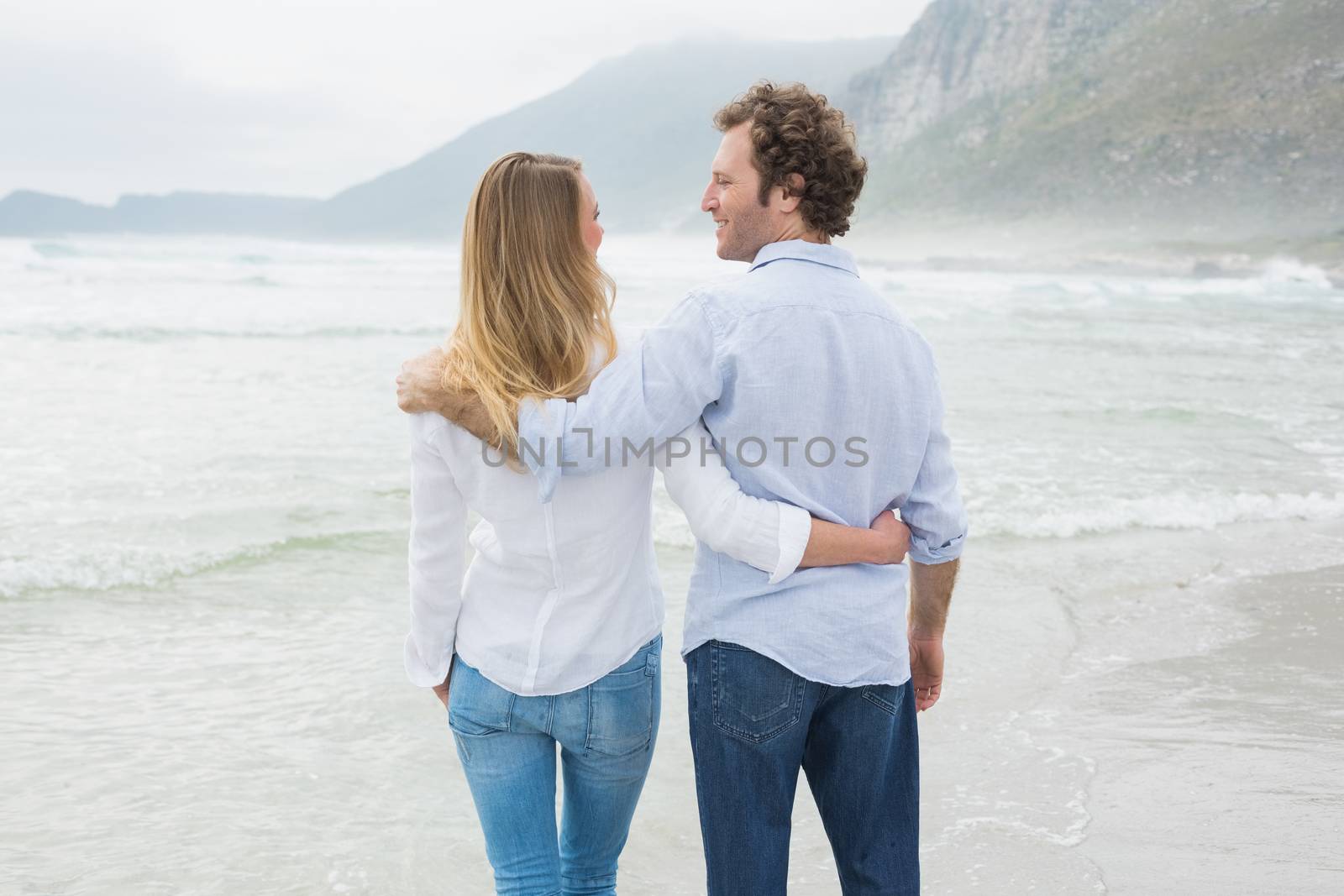 Rear view of a romantic couple at beach by Wavebreakmedia