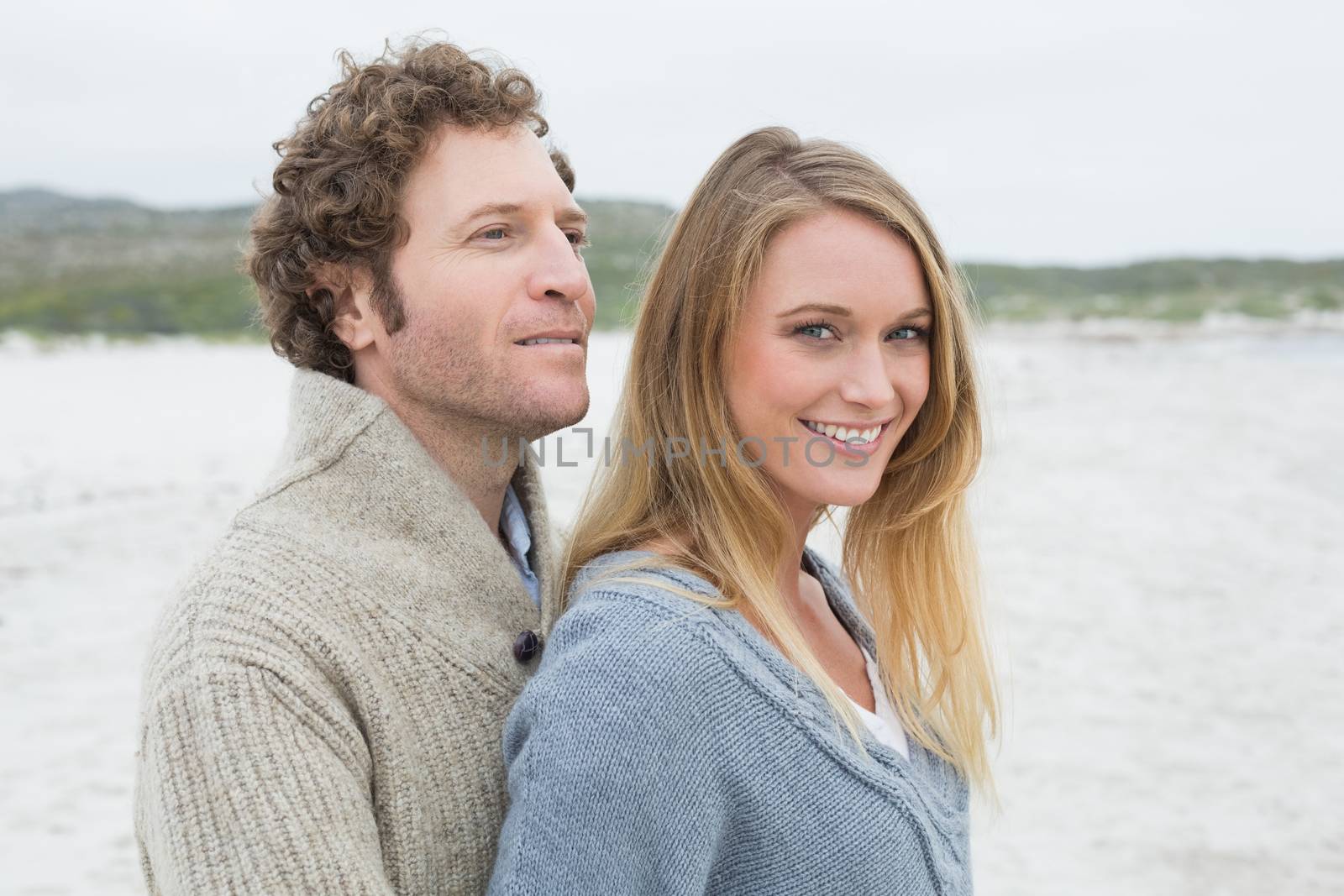 Relaxed romantic young couple at beach by Wavebreakmedia