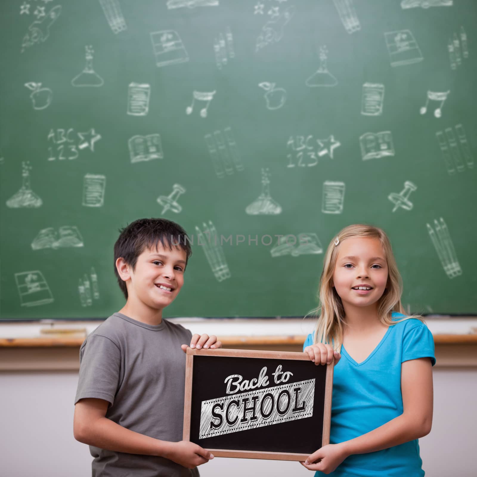 Back to school message against cute pupils showing chalkboard