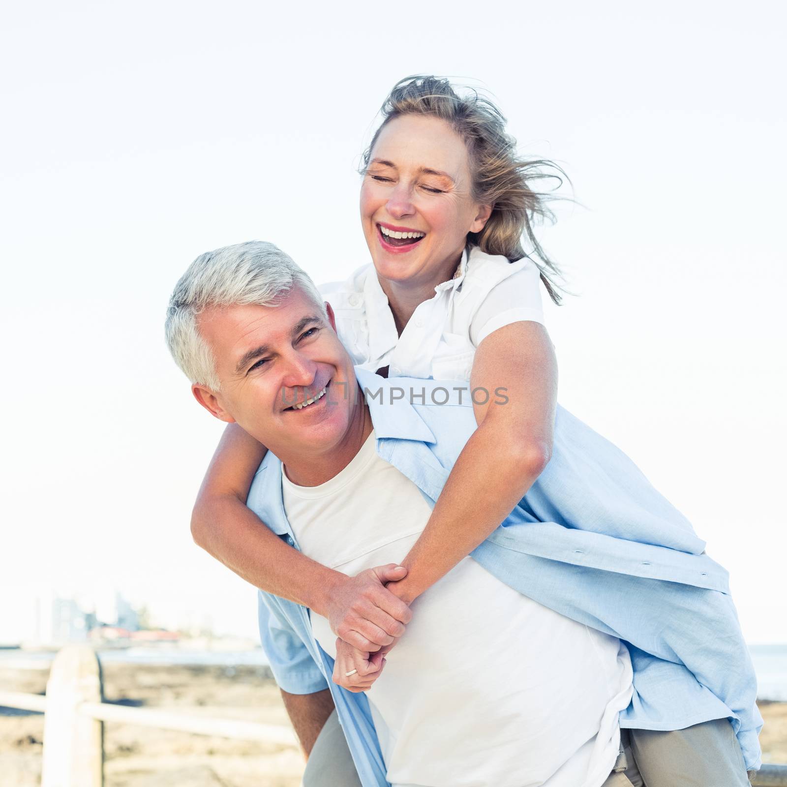 Casual couple having fun by the sea on a sunny day