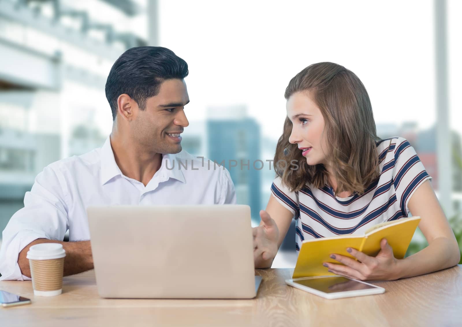 Digital composite of Business people at a desk using a computer