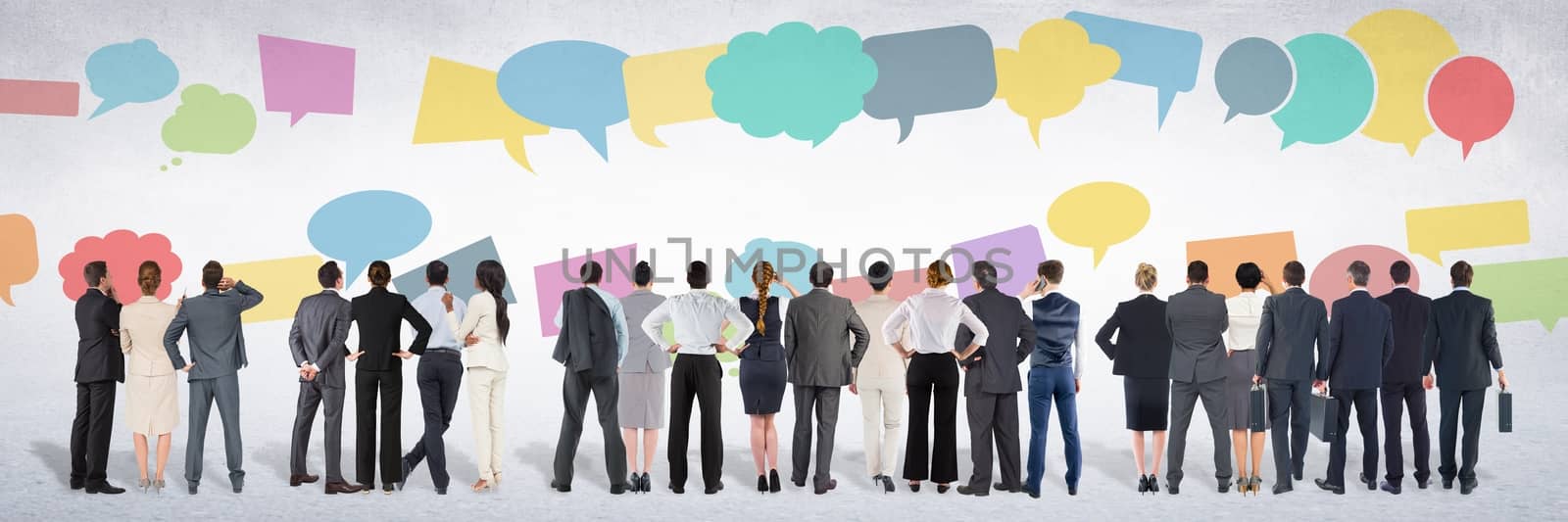 Group of business people standing in front of colorful chat bubbles by Wavebreakmedia