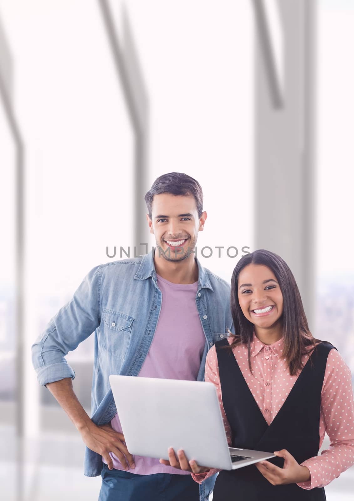 Digital composite of Happy business people holding a computer