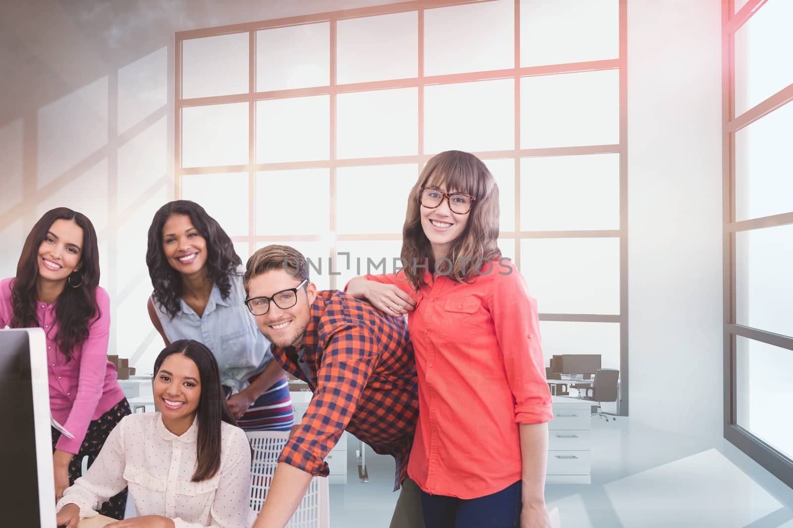 Digital composite of Happy business people at a desk using a computer