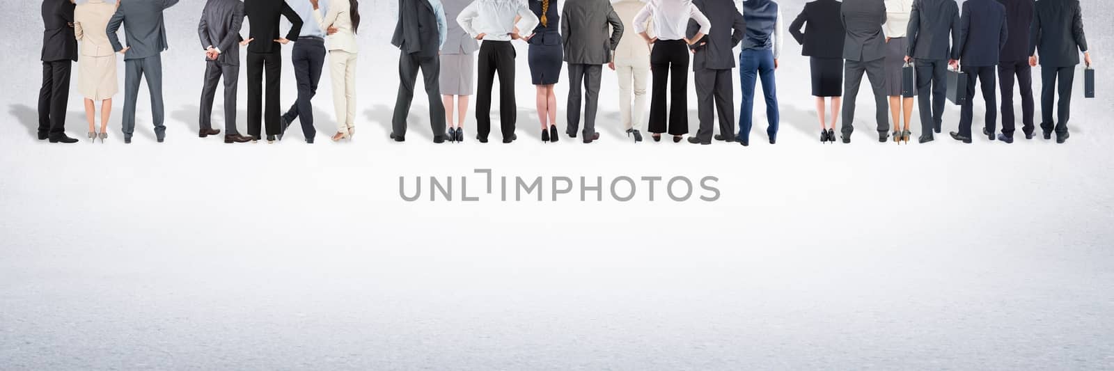 Group of business people standing in front of blank grey background by Wavebreakmedia