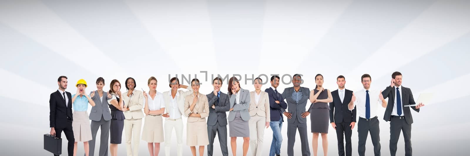 Group of business people standing in front of bright grey background by Wavebreakmedia