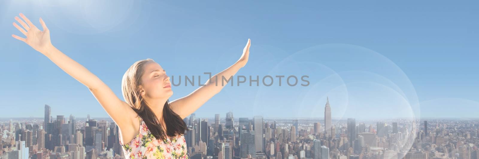 Digital composite of Millennial woman with arms out against skyline and Summer sky with flare