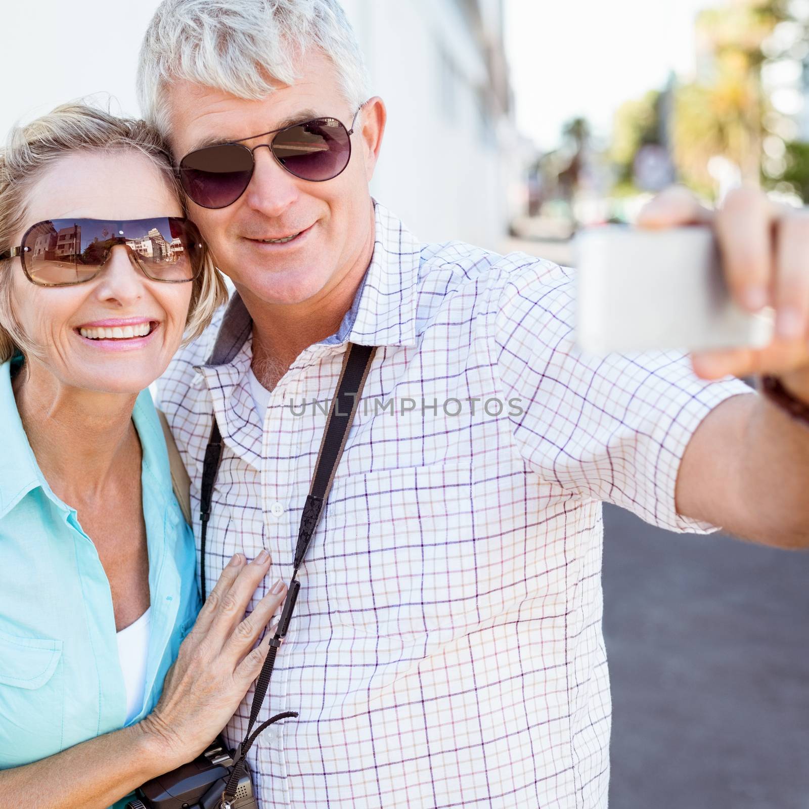 Happy tourist couple taking a selfie in the city by Wavebreakmedia