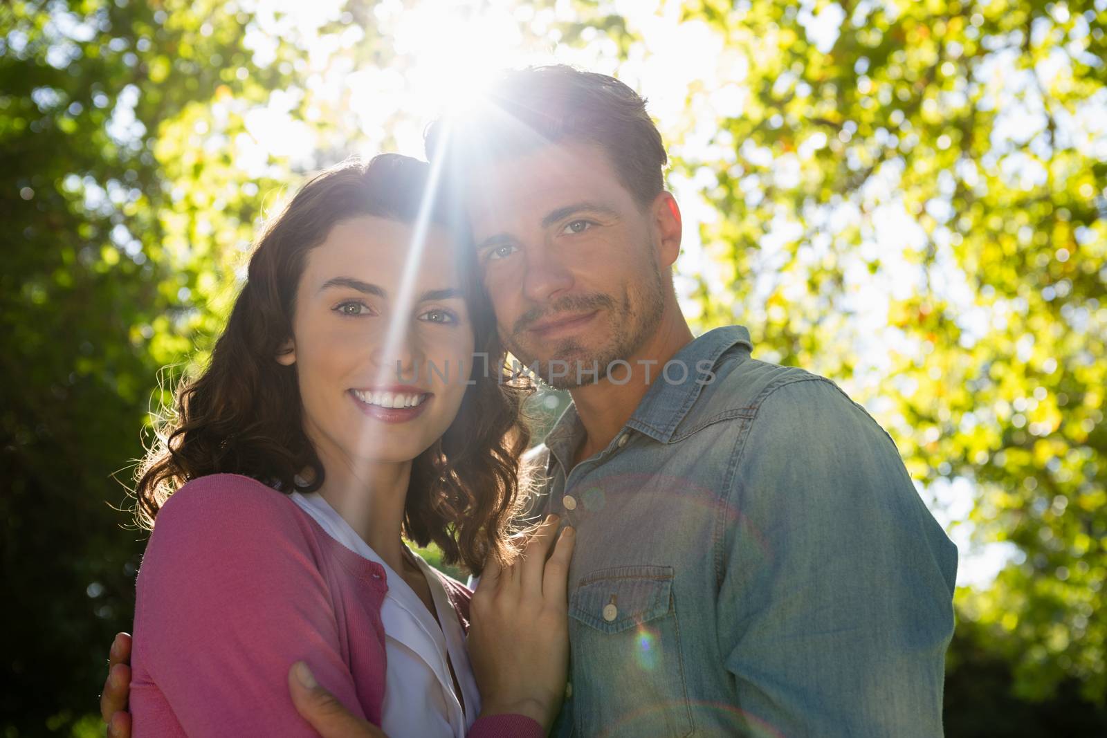 Portrait of romantic couple holding hands in garden