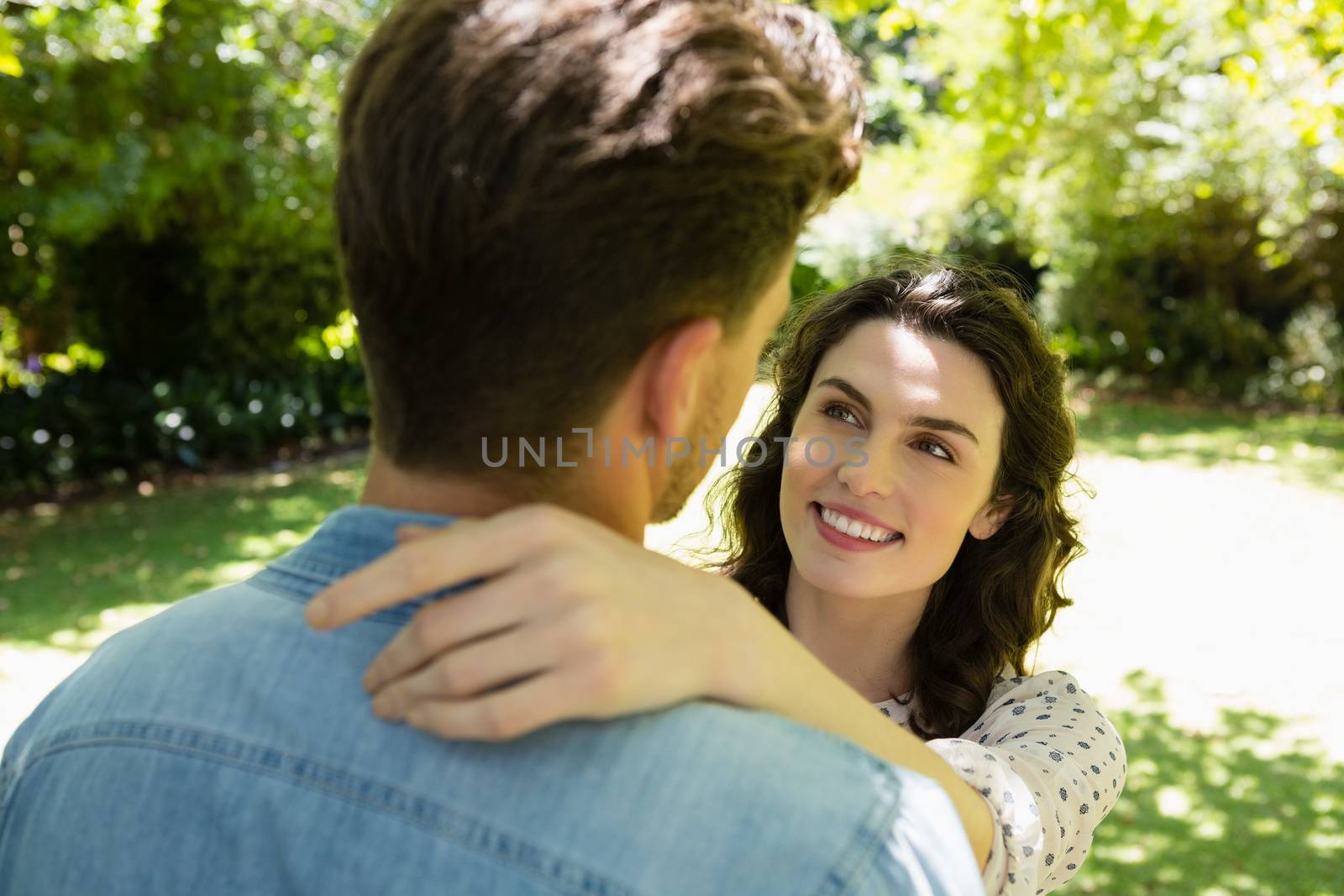 Romantic couple looking face to face in garden by Wavebreakmedia