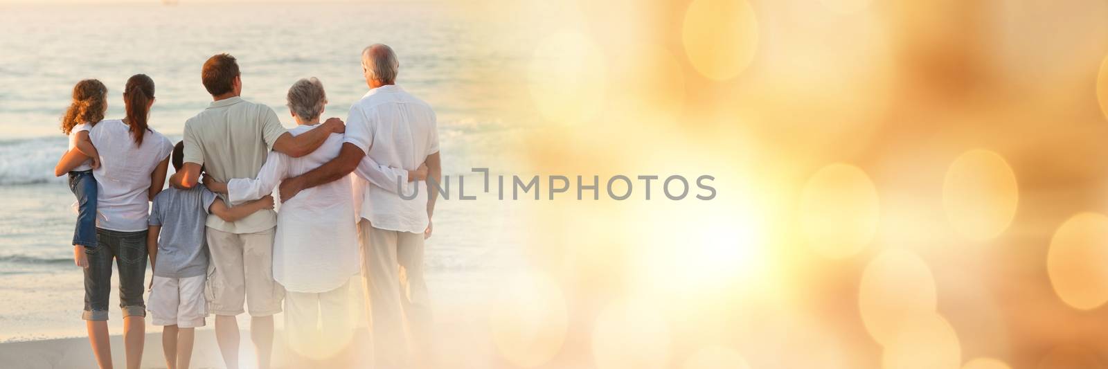 Digital composite of Family standing on beach with backs to camera wide shot