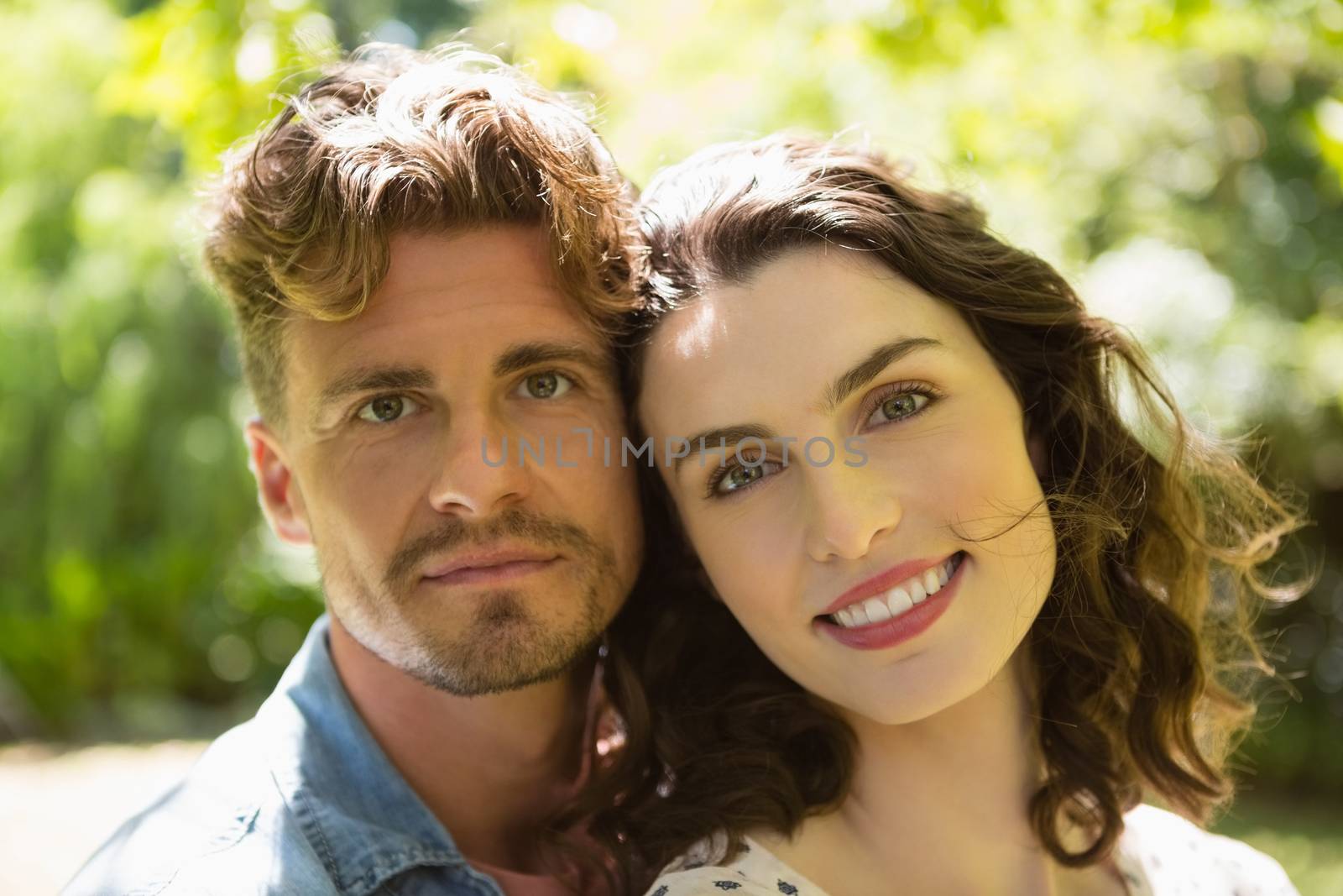 Portrait of romantic couple in garden on a sunny day