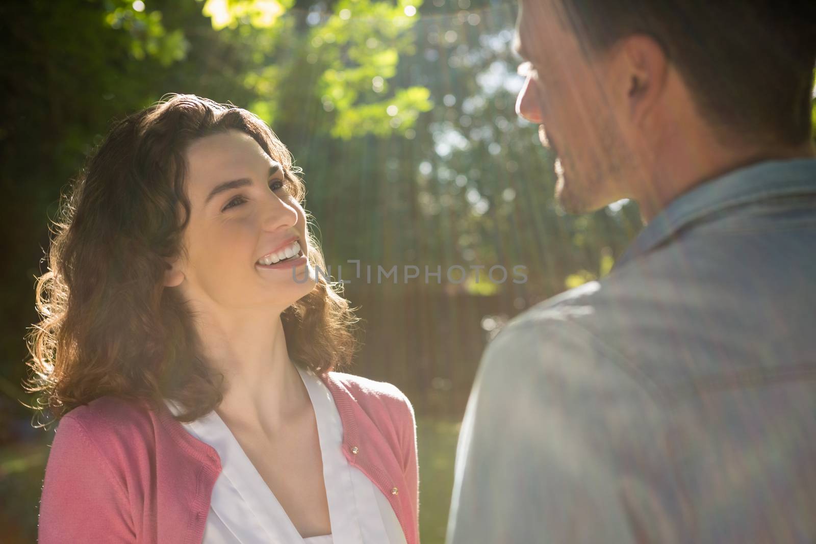 Romantic couple looking face to face in garden on a sunny day