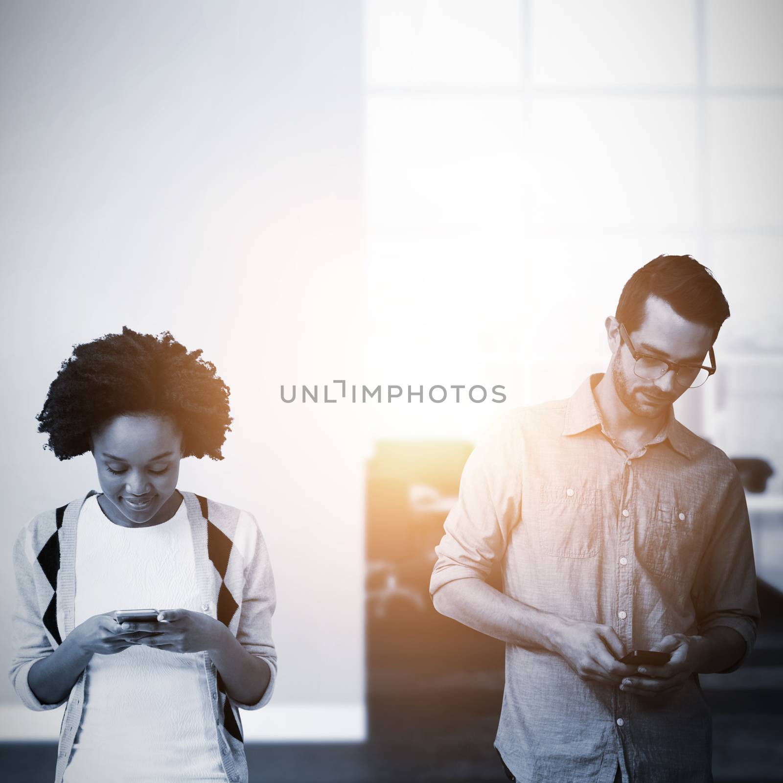 Composite image of two people occupying by their smartphone by Wavebreakmedia