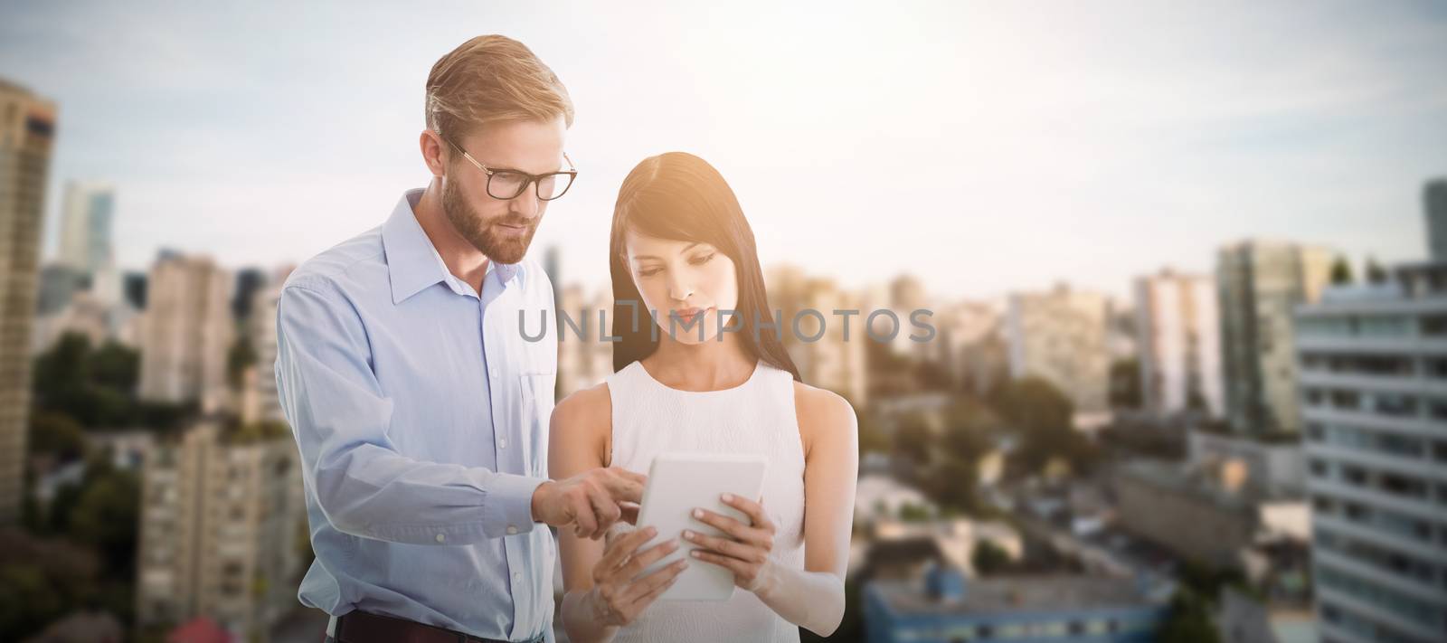 Composite image of business people looking at tablet by Wavebreakmedia