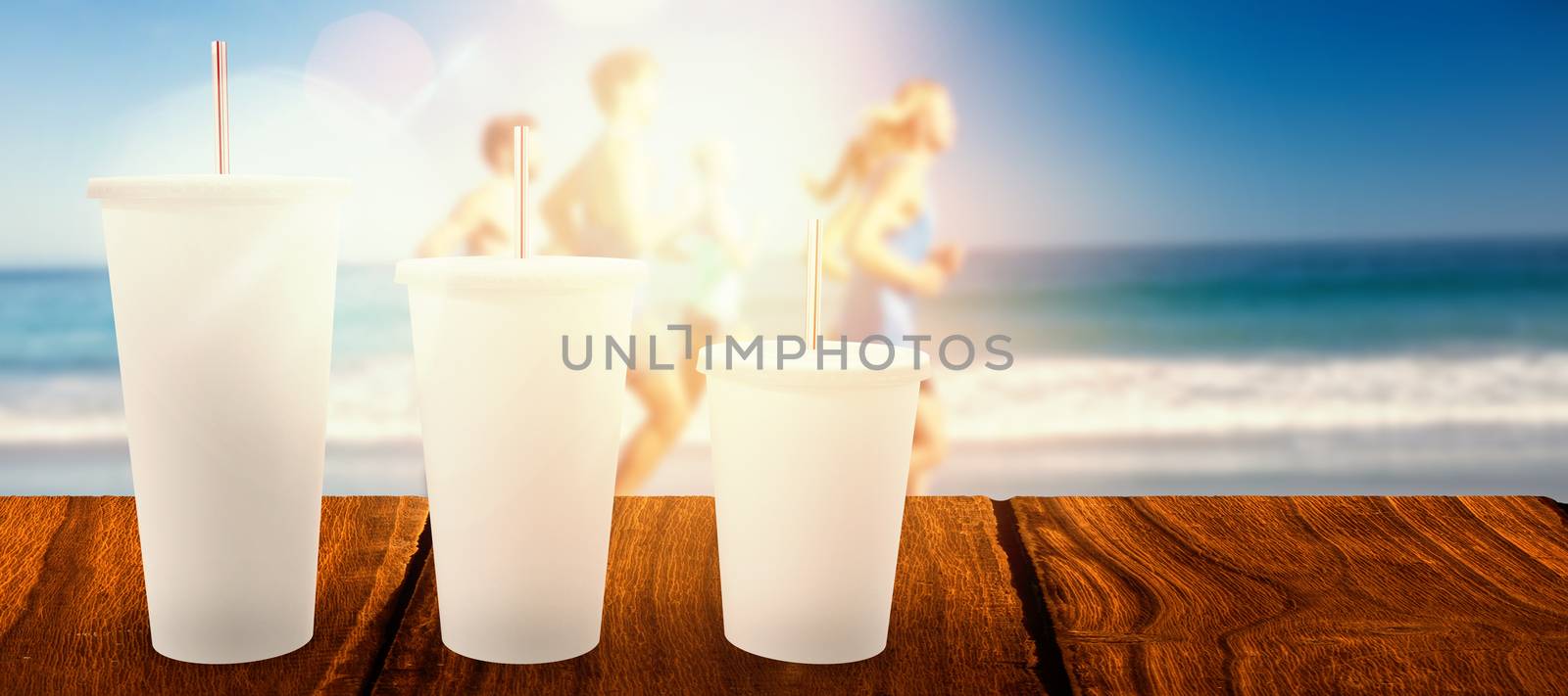 White cups over white background against people jogging on beach