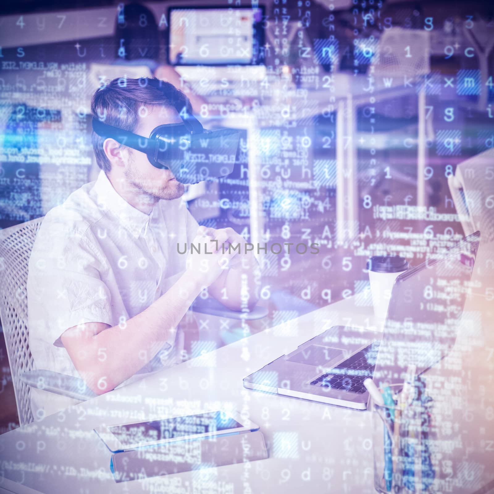 Male executive wearing virtual reality headset at table in office