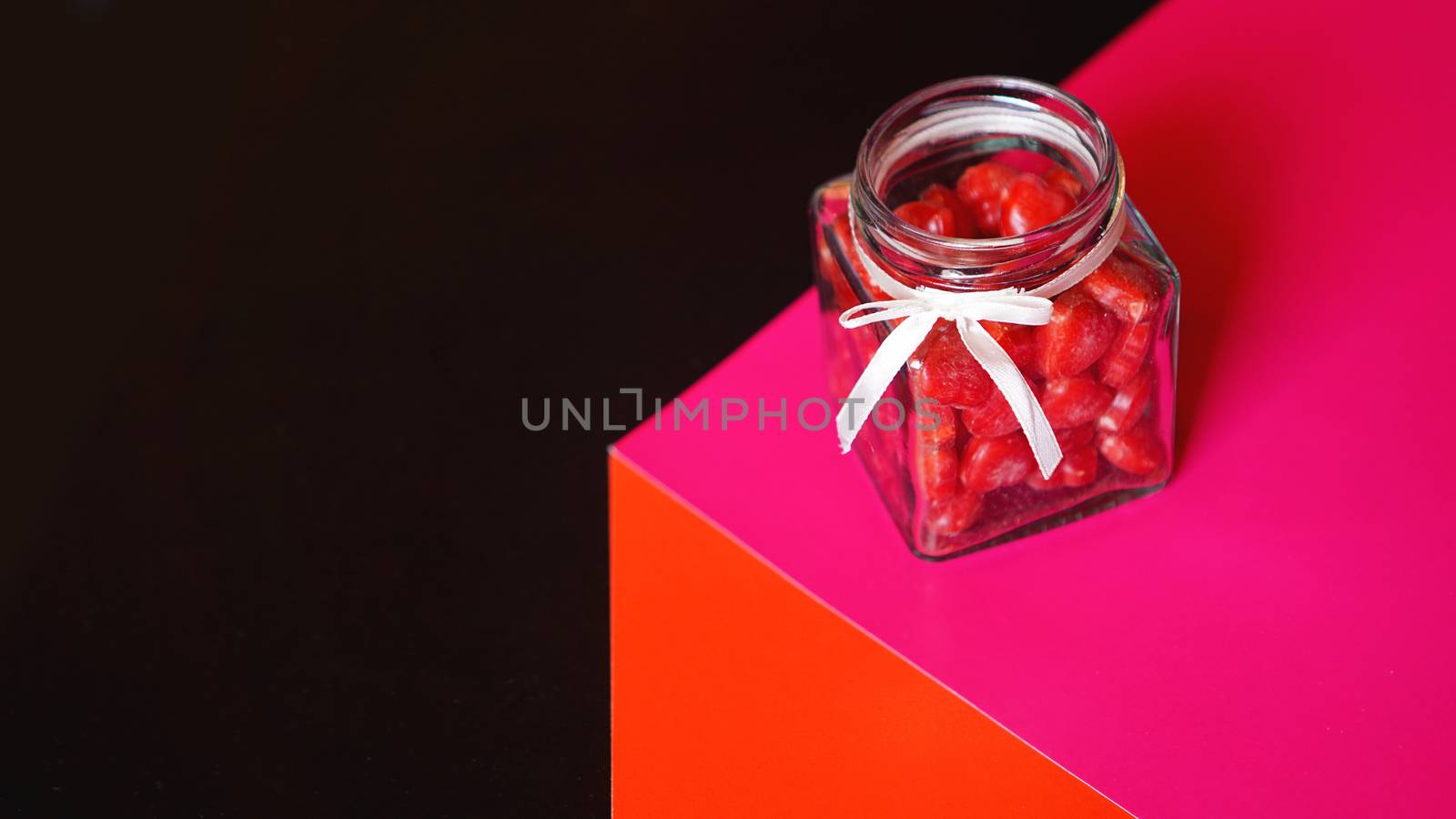 Valentine day and love concept. Hearts in jar with red and black background