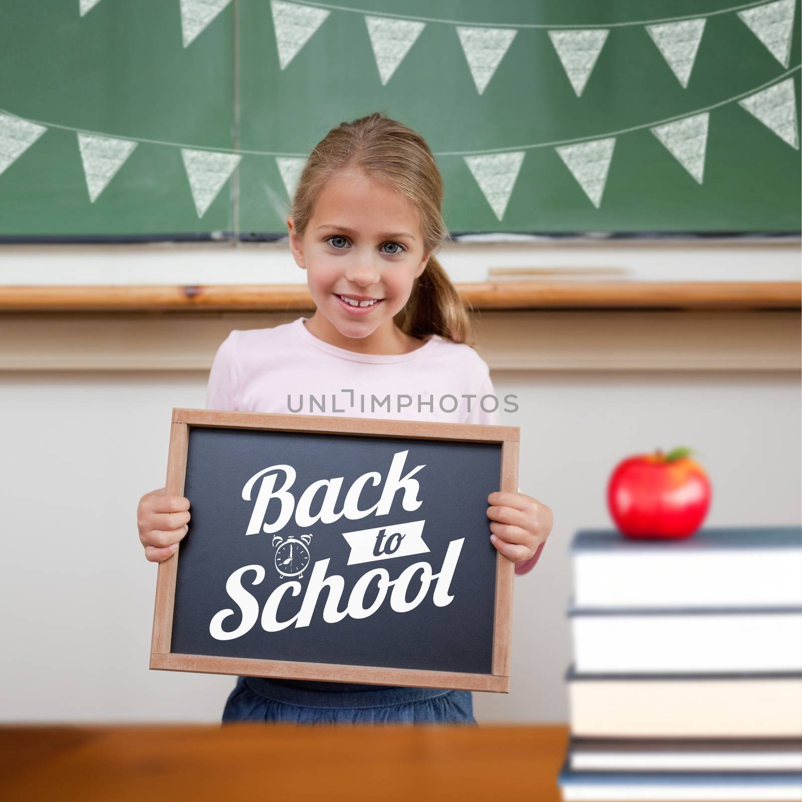 Back to school message against cute pupil showing chalkboard