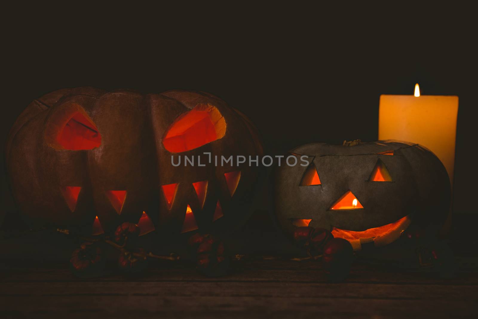 Jack o lantern with candles in darkroom during Halloween by Wavebreakmedia