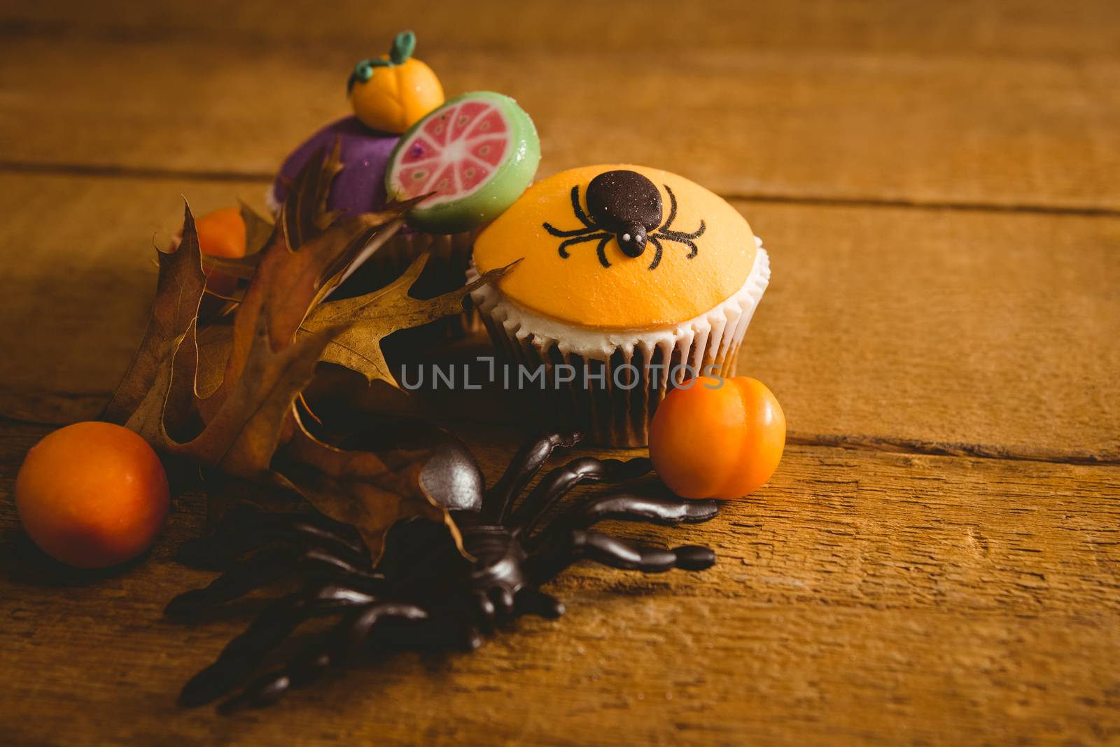 High angle view of Halloween decorations with cup cake on table