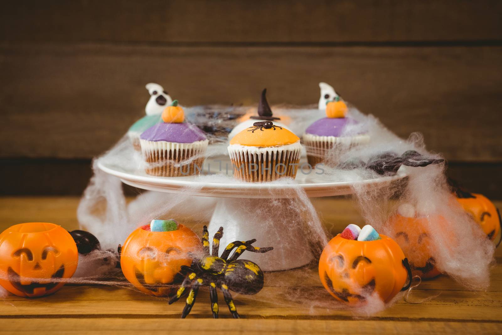Sweet food on wooden table during Halloween by Wavebreakmedia