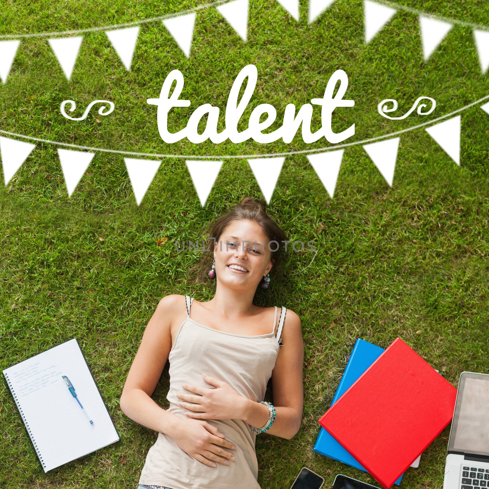 The word talent and bunting against pretty student lying on grass