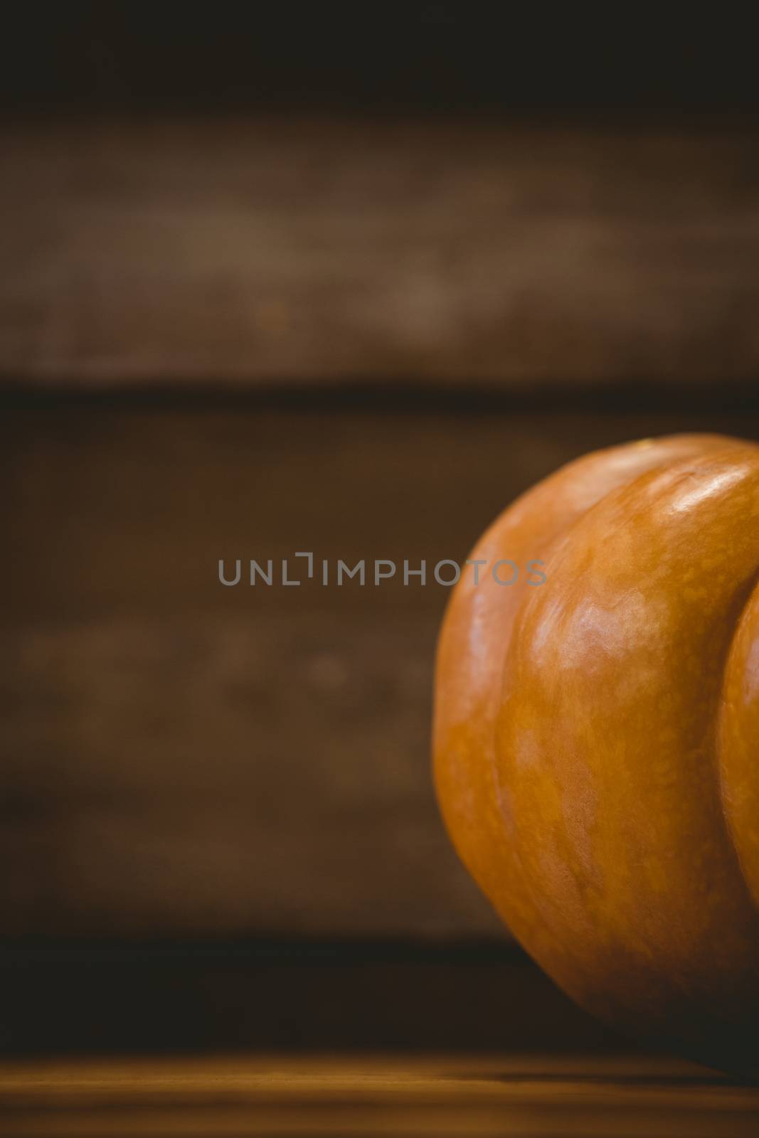 Cropped image of pumpkin on wooden table during Halloween