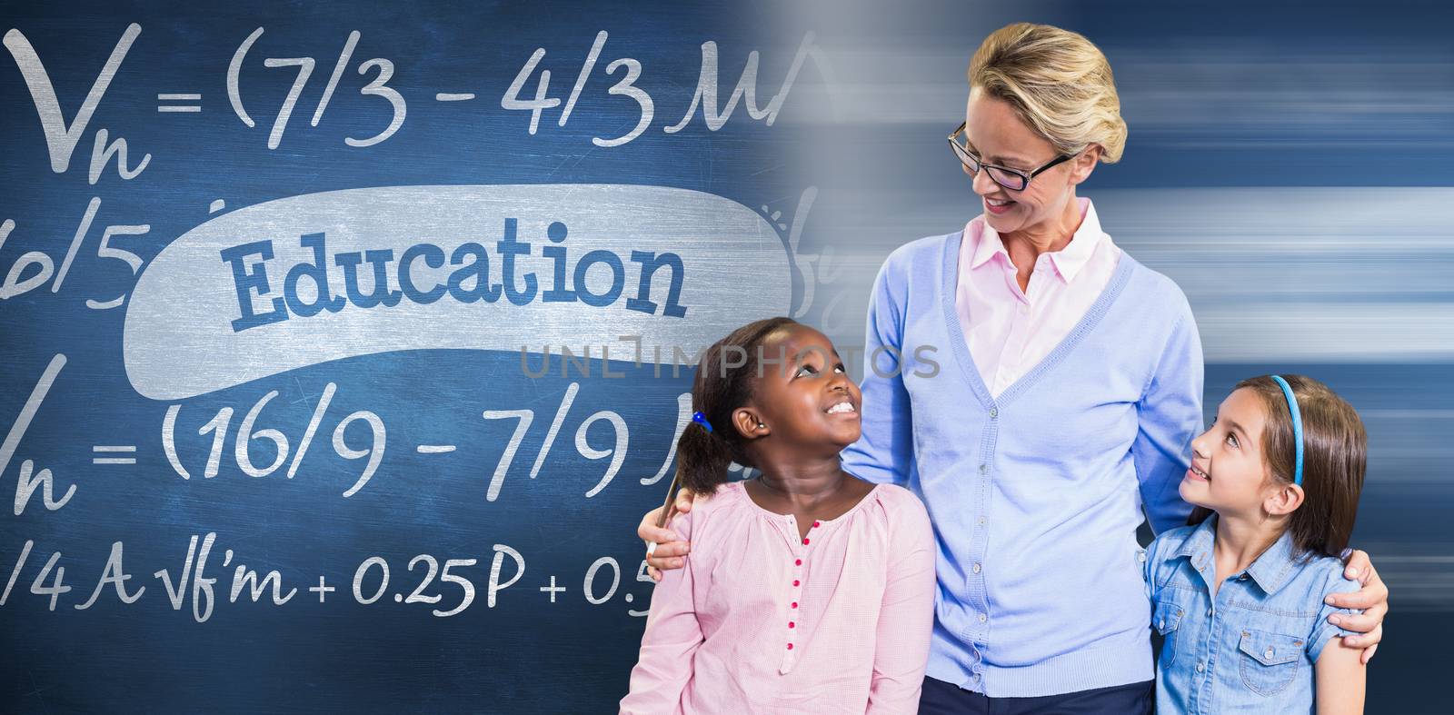 Smiling teacher with students  against education against blue chalkboard