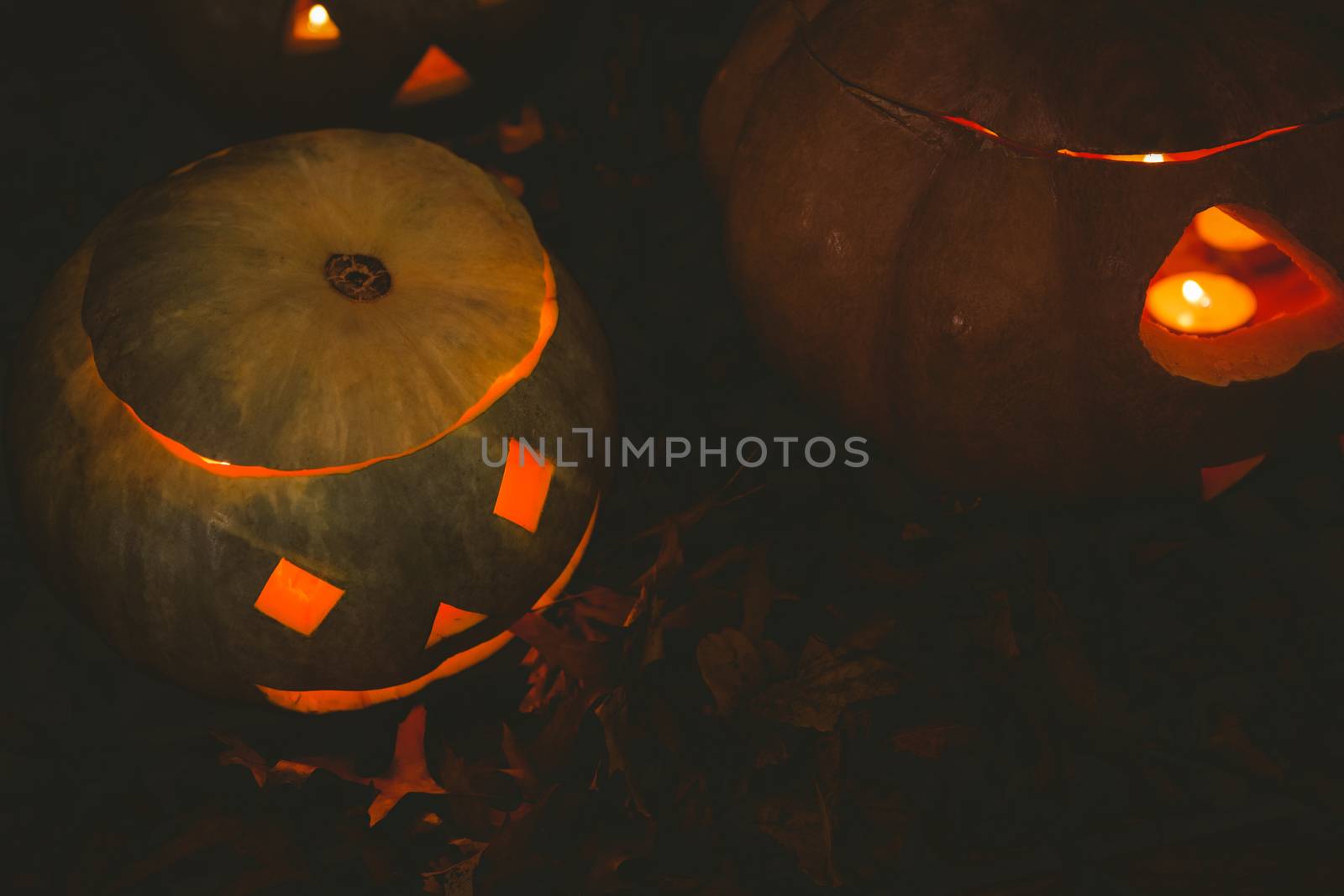 High angle view of jack o lantern glowing in darkroom during Halloween