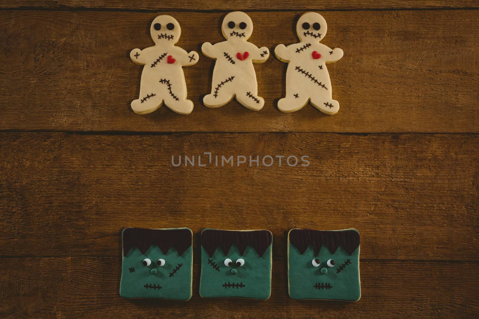 Overhead view of Halloween cookies arranged on wooden table