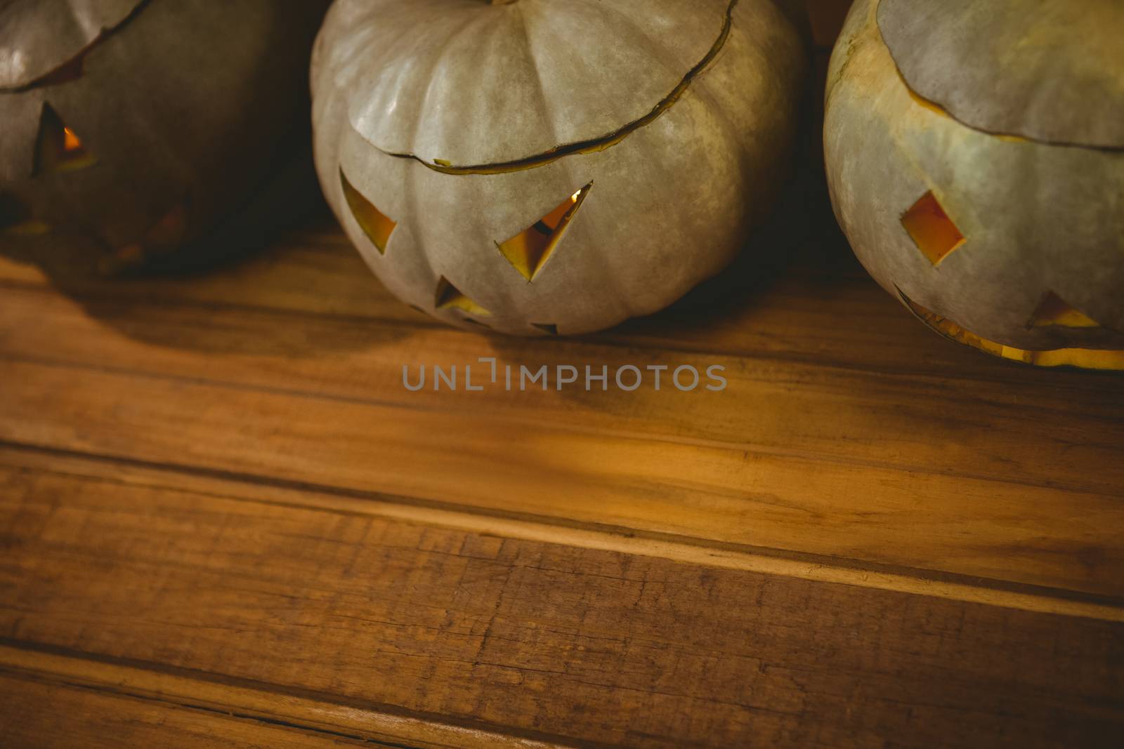 High angle view of jack o lanterns arranged on table during Halloween