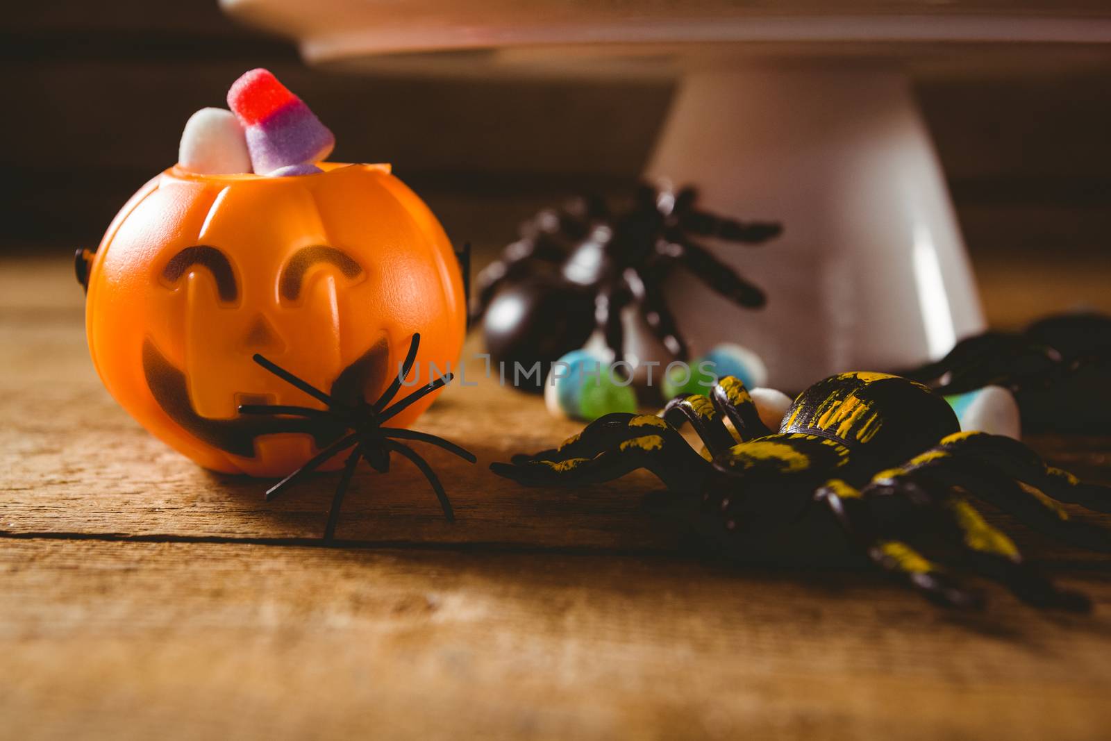 Close up of decorations with candies on wooden table during Halloween