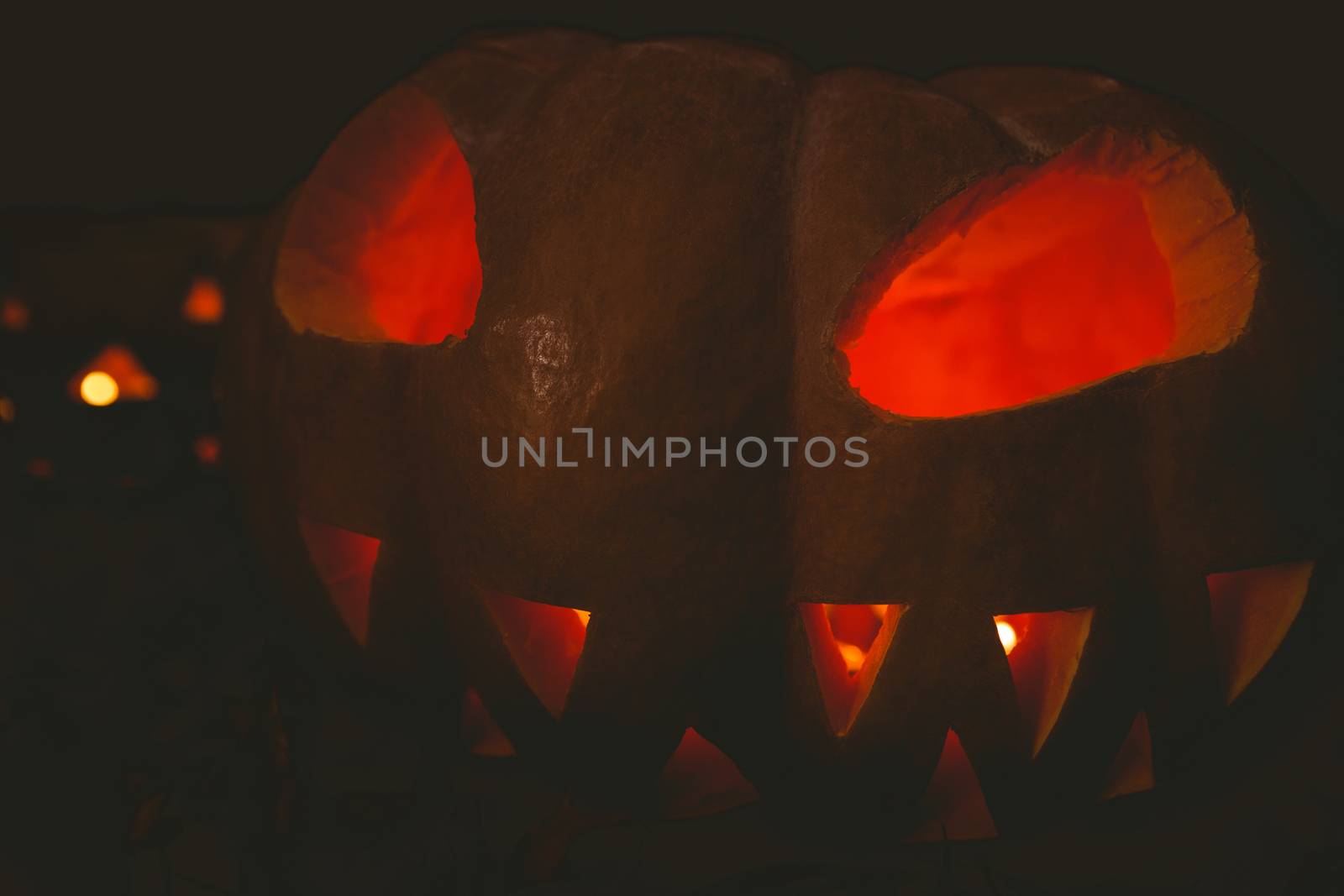 Jack o lantern glowing in darkroom during Halloween by Wavebreakmedia