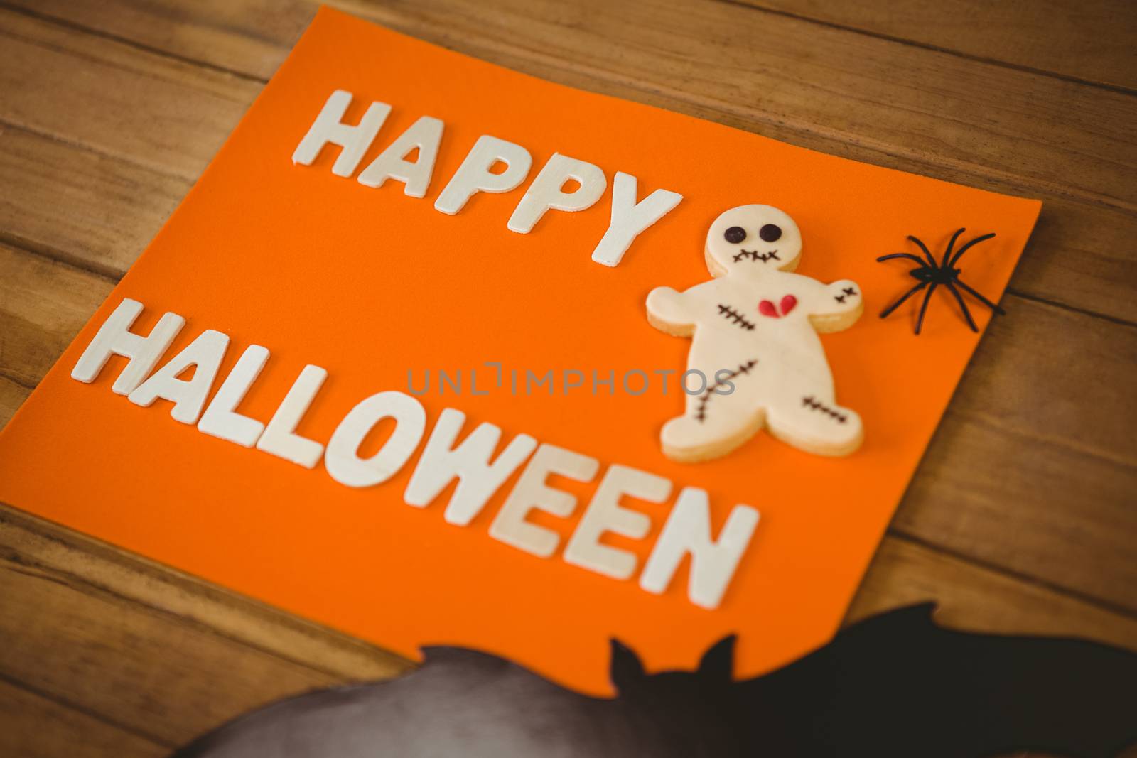 Happy Halloween text with cookies on orange paper by Wavebreakmedia