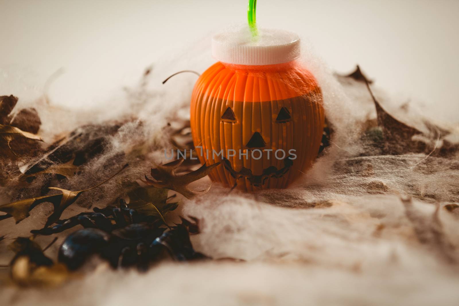 Jack o lantern container with autumn leaves and decoration during halloween
