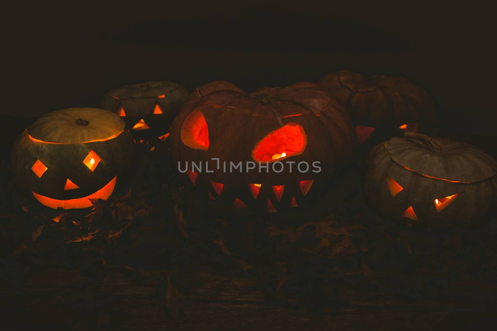 Illuminated jack o lanterns in darkroom during Halloween