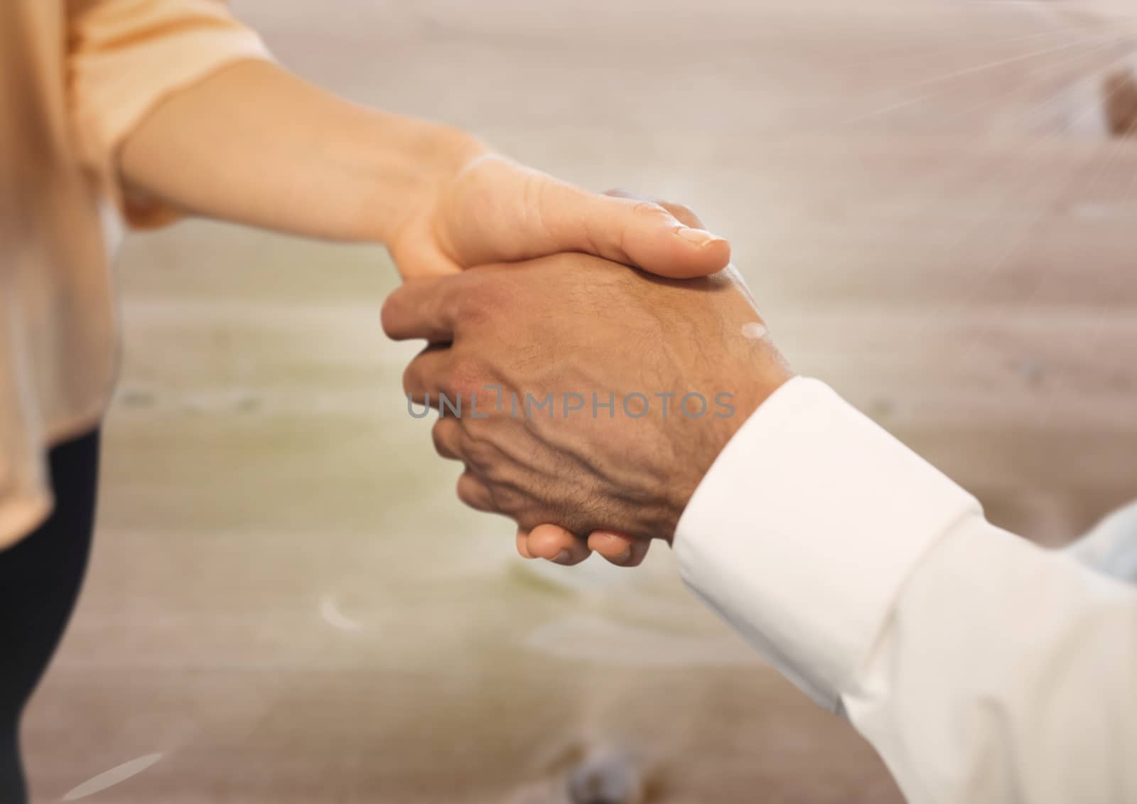 Digital composite of Business people shaking hands against wood floor background