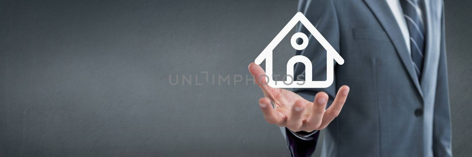 Hand holding a house icon as house insurance concept by Wavebreakmedia