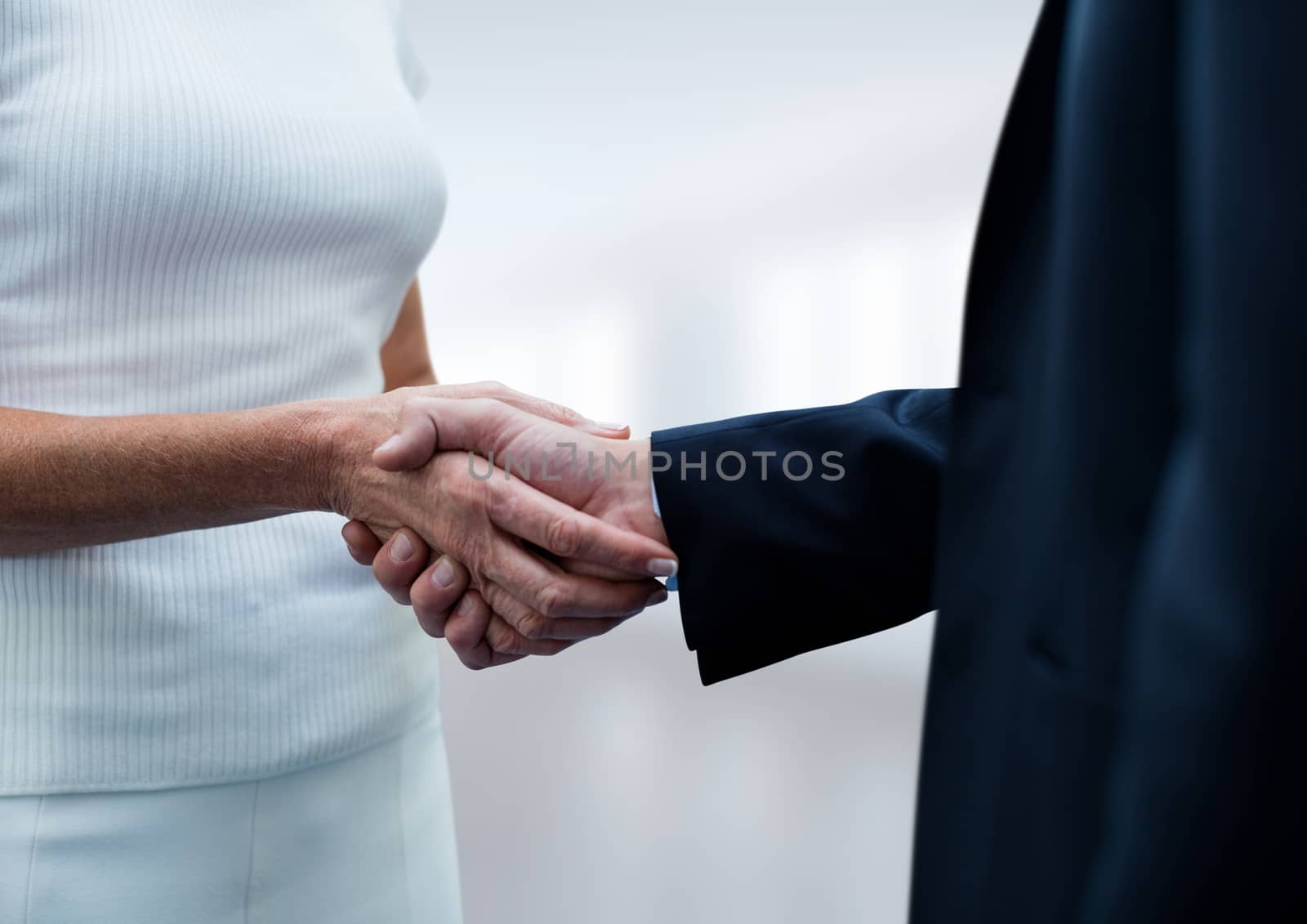 Digital composite of Business people shaking hands against white background