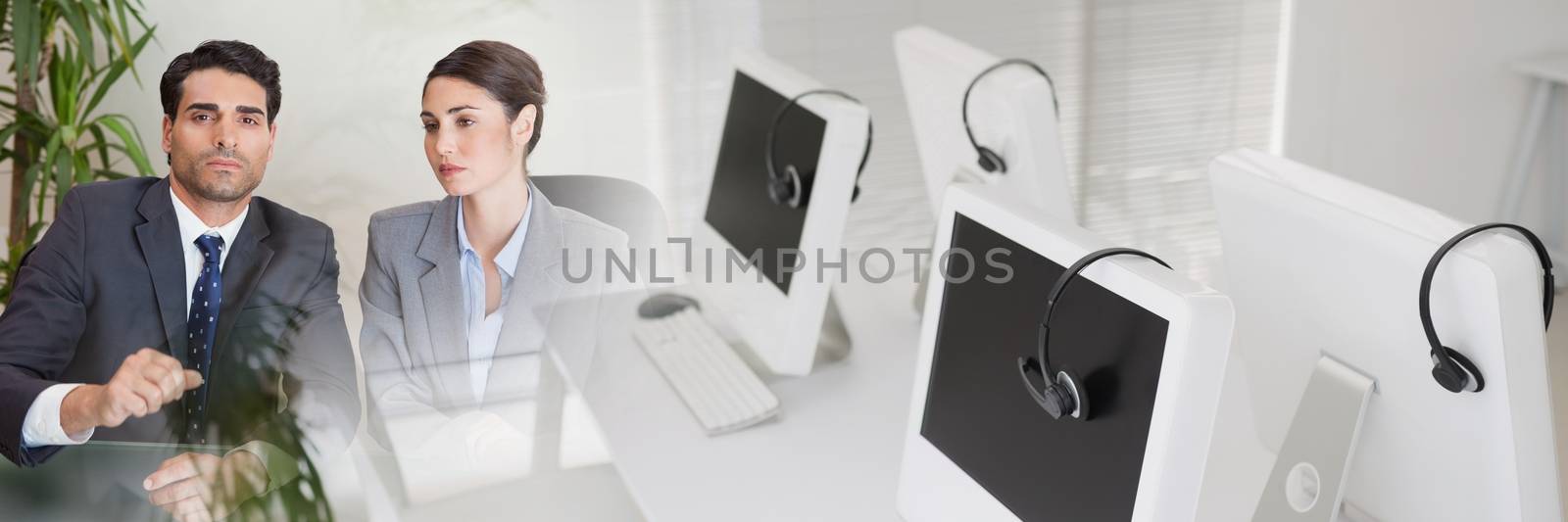 Digital composite of Serious business people sitting at a table