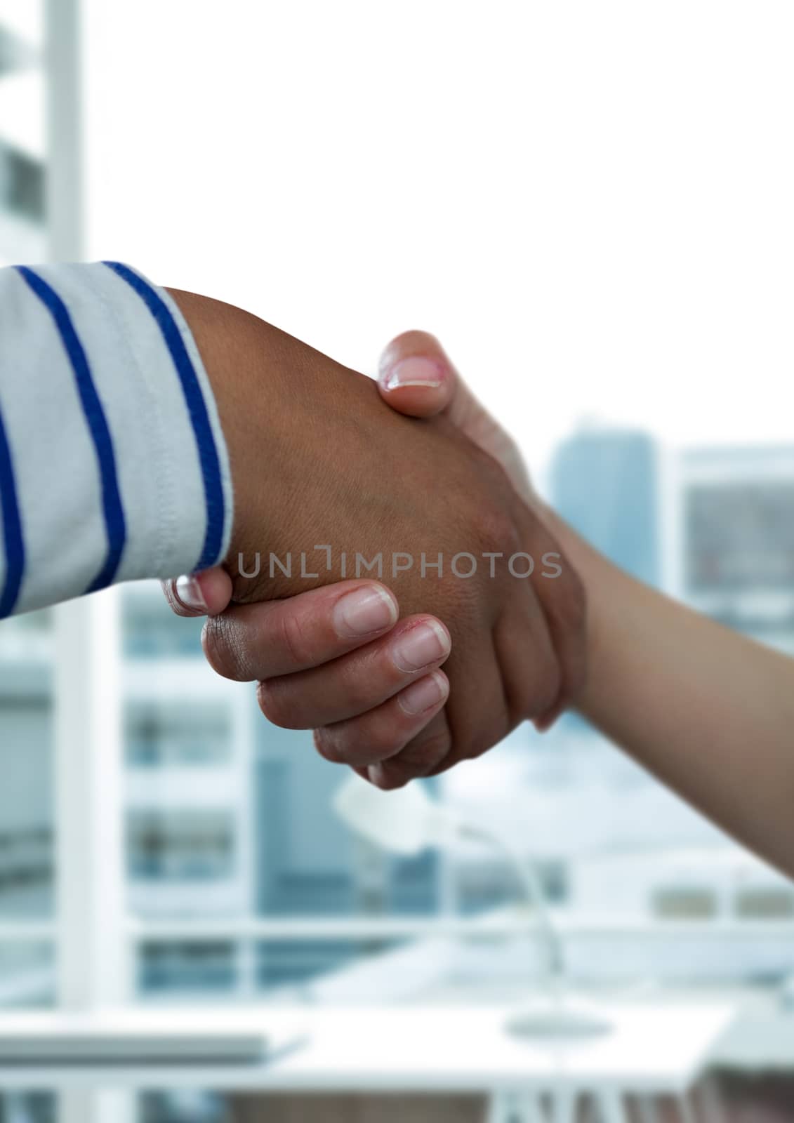 Digital composite of Business people shaking hands against office background