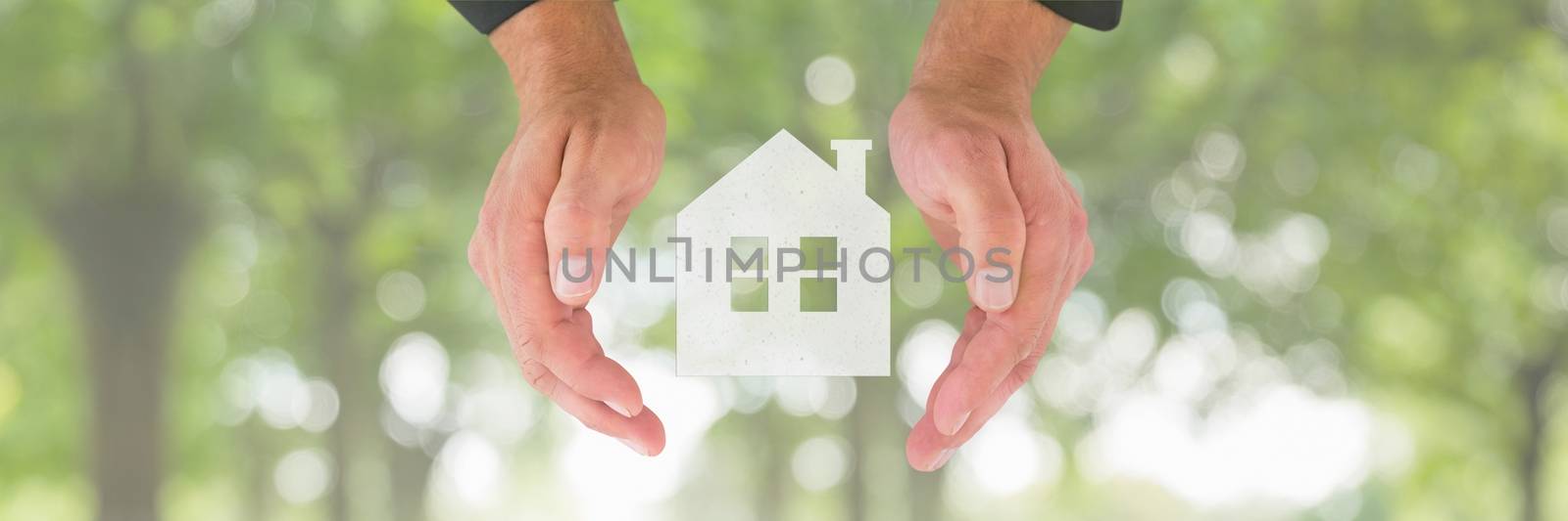 Hands holding a house icon as house insurance concept by Wavebreakmedia