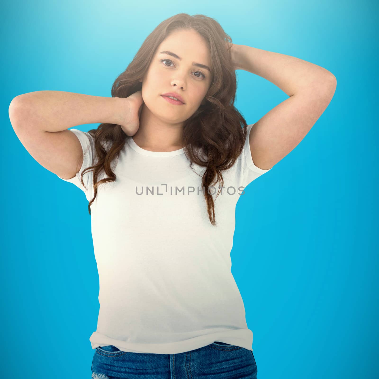 Beautiful brunette posing against blue background