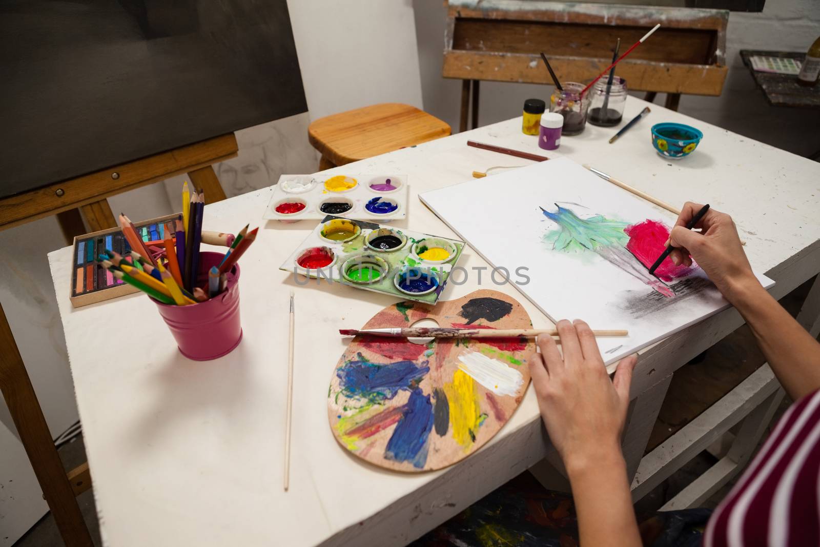 Woman drawing on book in drawing class by Wavebreakmedia