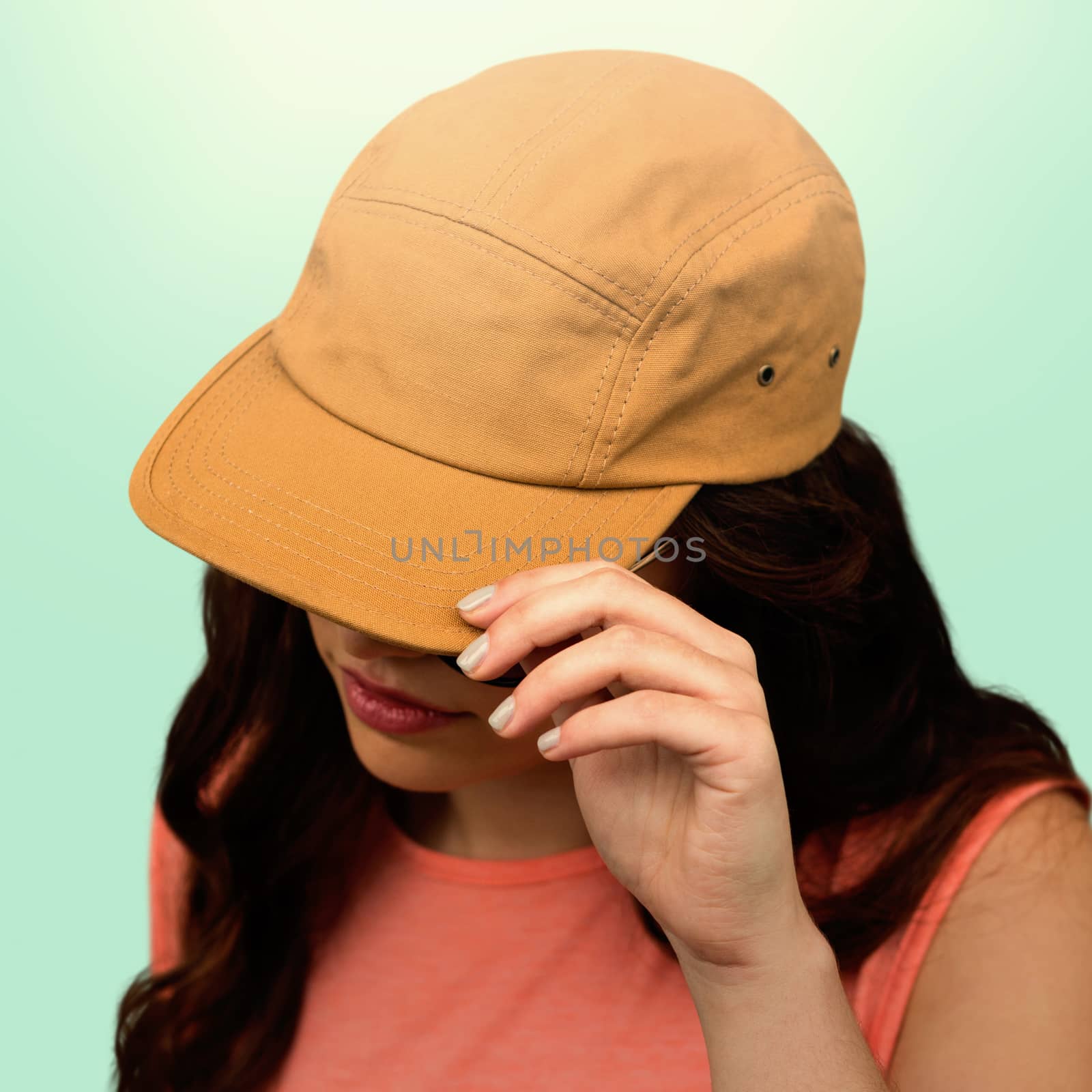 Composite image of woman with long hair wearing brown cap by Wavebreakmedia